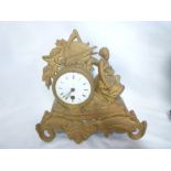 A French mantel clock with circular enamelled dial in gilt spelter scroll case decorated with a