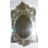 A late 19th/early 20th century Venetian wall mirror with central bevelled oval panel surrounded by