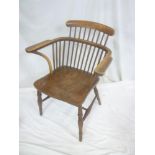 A 19th Century elm and beech Windsor style armchair with spindle back and shaped seat on turned