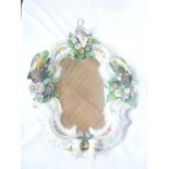 A 19th century Continental porcelain framed mirror decorated in relief with birds,