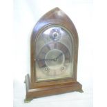 A German bracket clock with silvered and gilt arched dial in inlaid mahogany Gothic arched case