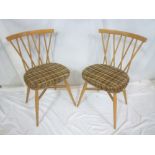 A set of six 1960's Ercol light elm dining chairs with crossed spindle backs and polished seats on