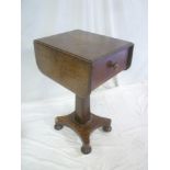 A Victorian mahogany drop-leaf work table with a single drawer in the frieze on facetted column