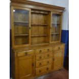 A 19th Century polished pine kitchen dresser with three drawers in the frieze above three central