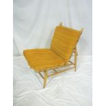 A 1960's Ercol light elm modular easy chair with original striped nylon cushions