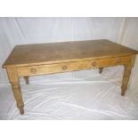 A 19th Century polished pine rectangular kitchen/dining table with two drawers in the frieze on