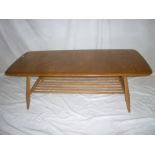 A 1960s Ercol light elm rectangular coffee table on turned supports