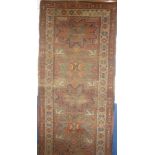 An early 19th Century Eastern hand-knotted wool rug with geometric decoration on red ground,