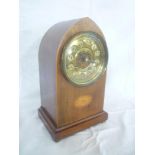 An Edwardian mantel clock with gilt decorated circular dial in inlaid mahogany Gothic arched case