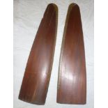A pair of old polished wood aircraft propeller tips with brass edging,