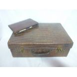 A good quality old crocodile leather suitcase with brass mounts together with a similar manicure