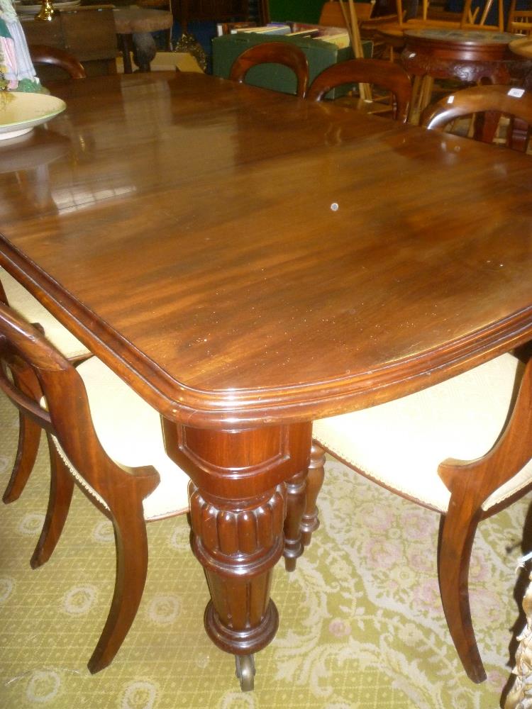 A Victorian mahogany rectangular extending dining table with one additional centre leaf on turned