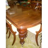 A Victorian mahogany rectangular extending dining table with one additional centre leaf on turned