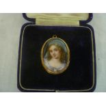 A Victorian pinchbeck oval brooch inset with a porcelain panel depicting a bust portrait of a