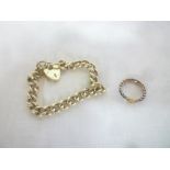 A silver chain-link bracelet with padlock clasp and a gold mounted dress ring with shield mount (2)