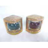 A small pair of copper ship's port and starboard bow lights with coloured glass lenses