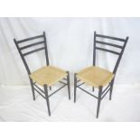 A set of four 1960's Gio Ponti black dining chairs with string work seats