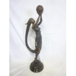 A 20th Century bronze Art Deco-style figure of a scantily clad female with long swept hair holding