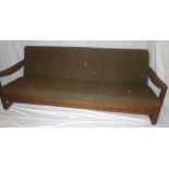 A 1960's teak three-piece suite by Guy Rogers comprising teak framed three-seat bed settee with