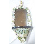 An ornate 19th Century porcelain framed wall mirror with scroll and floral decorated frame,