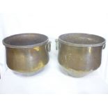 A pair of Middle Eastern brass tapered bowls with ring handles,