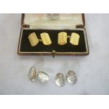 A pair of 9ct gold rectangular cufflinks with engraved decoration and a pair of silver oval