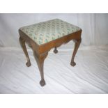 A 19th Century mahogany rectangular stool with tapestry seat on cabriole legs with claw and ball