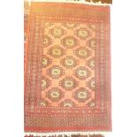 A 20th Century Eastern wool rug with geometric decoration on red ground 48" x 32"