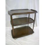 A 1960's Ercol dark elm three-tier tea trolley