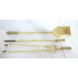 A Victorian brass three-piece companion set comprising poker with ornate handle,