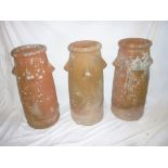 Three matching 19th Century terracotta chimney pots with raised decoration 27" high