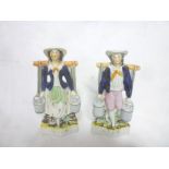 A pair of Staffordshire pottery flat back figures of a milkmaid and milk boy