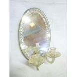 A 19th century oval truth mirror with attached glass twin candle sconces,