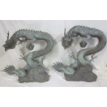 A pair of large 20th Century bronze figures of Chinese dragons on shaped bases,