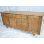 A good quality 1960's oak sideboard with a single frieze drawer above cupboard enclosed by two
