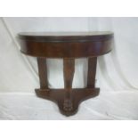 A Victorian mahogany semi-circular side table with carved scroll support with paw mounted plateau