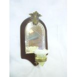 A 19th Century velvet covered wall mirror with arched panel surmounted by a classical winged
