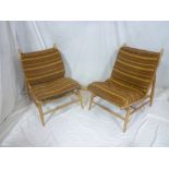 A pair of 1960's Ercol light elm modular easy chairs with original striped nylon cushions