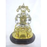 A good quality brass skeleton clock with silvered circular dial on stained wood stand,