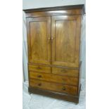 A Victorian figured mahogany linen press with sliding trays enclosed by two panelled doors above