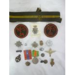 A selection of various military badges including two National Fire Service cloth circular badges