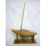 A small wooden pond yacht with weighted keel and linen sails