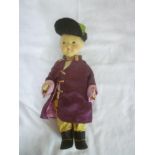 An old china and composition Chinese figure doll in ceremonial costume 10" long