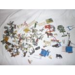 A selection of Britains Ltd farmyard items including numerous labourers and figures, cattle,