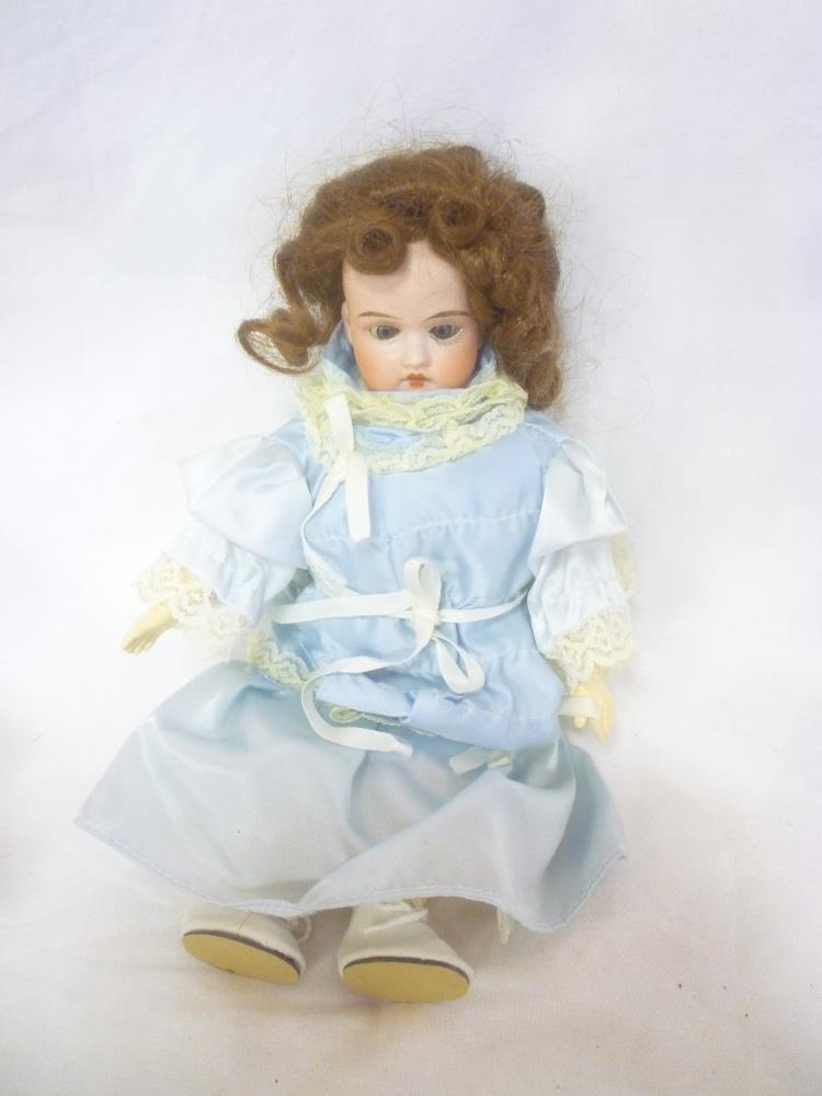 A German porcelain headed doll, the head marked "Made in Germany 132-15 D.E.P.