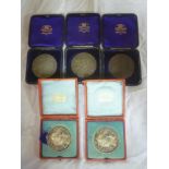 Five British Dairy Farmers Association cased medallions including two silver 1909 medallions