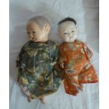 Two old composition Chinese baby dolls in silk robes 10" high