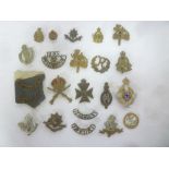 A selection of original military cap badges and buttons including bronze Worcestershire Regiment
