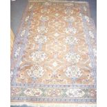 An Eastern wool rectangular carpet with geometric and floral decoration on brown,