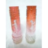 A pair of late Victorian cranberry tinted glass tapered vases with Mary Gregory-style scenes of a